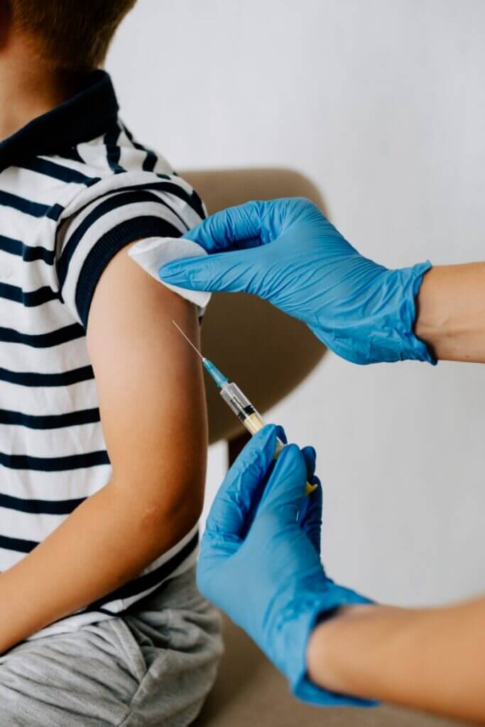Healthcare provider administering vaccine to child