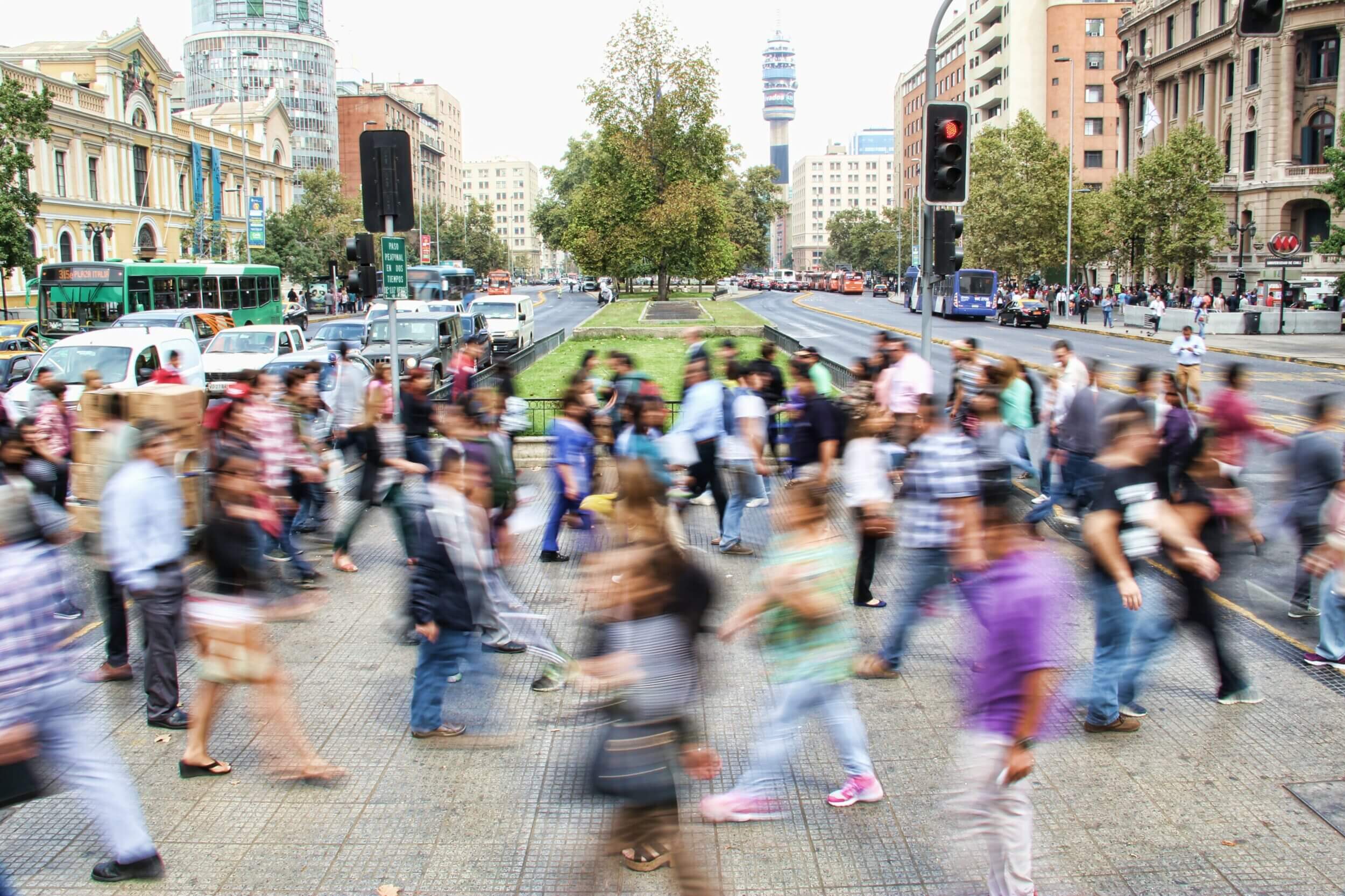 Mob of people walking across the street