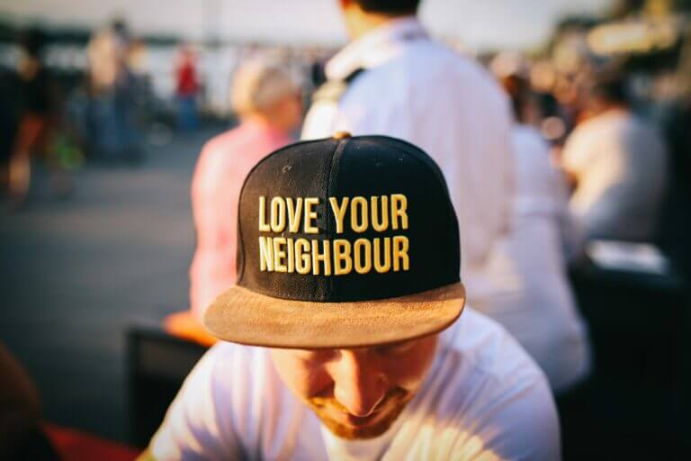 Man wearing hat that says Love Your Neighbour